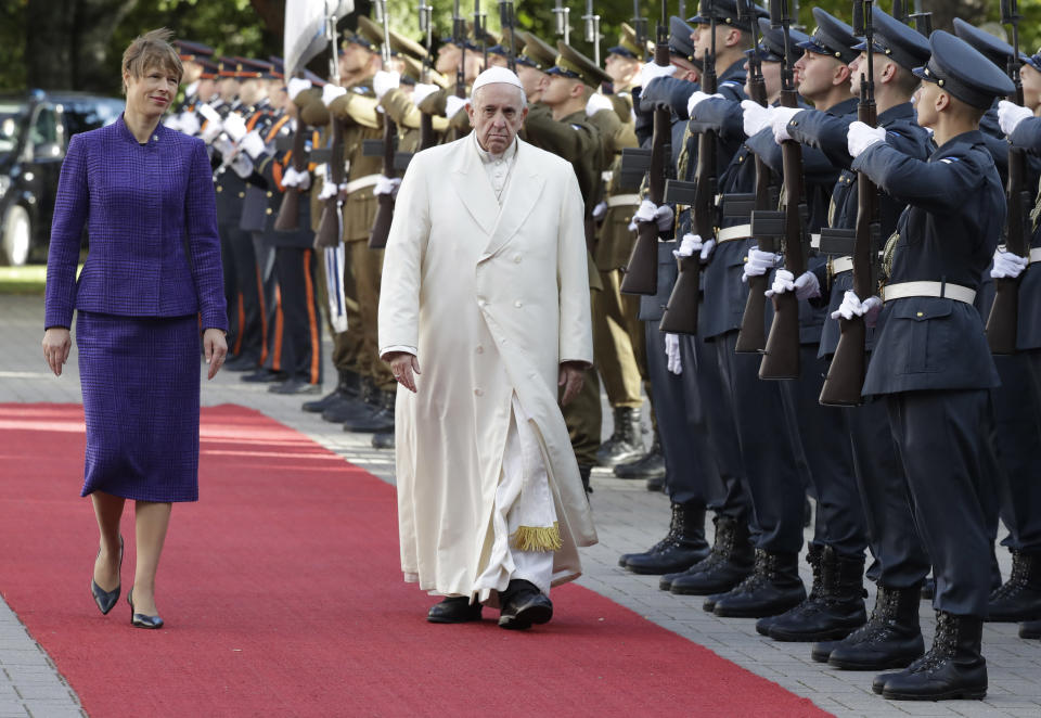 Pope Francis, right, and President of Estonia Kersti Kaljulaid, review the honor guard during the welcome ceremony at the Kadriorg Presidential Palace, Estonia, Tuesday, Sept. 25, 2018. Pope Francis concludes his four-day tour of the Baltics visiting Estonia. (AP Photo/Andrew Medichini)