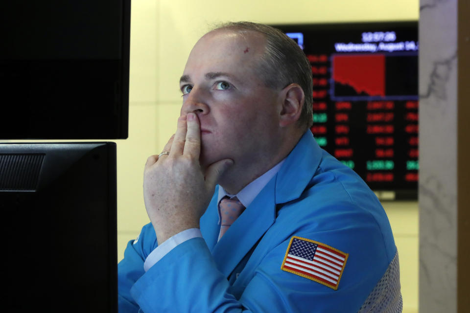 Specialist Edward Loggie works on the floor of the New York Stock Exchange, Wednesday, Aug. 14, 2019. Stocks are falling sharply after the bond market threw up another warning flag on the economy. (AP Photo/Richard Drew)