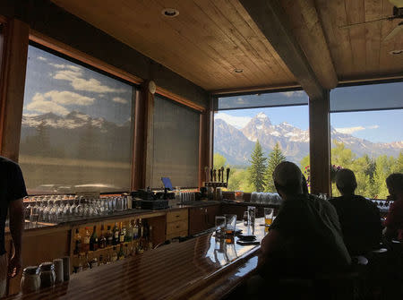 Guests at The Spur Bar view the Teton Mountain Range from their seats at the counter in Moose, Wyoming, U.S. July 12, 2017. Picture taken July 12, 2017. REUTERS/Ann Saphir