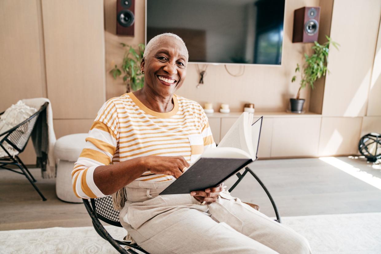 Senior woman  reading a book in the living room