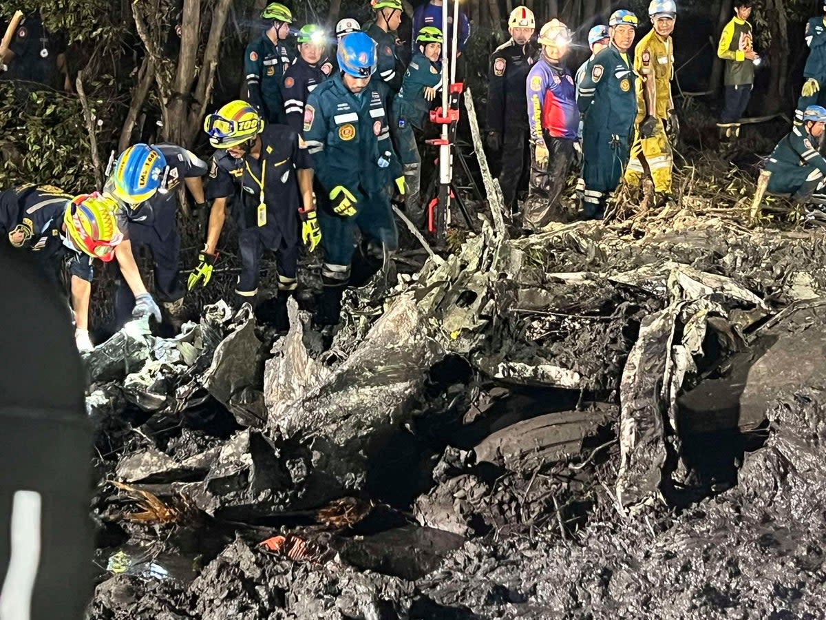 A rescue team work at the site of the crash in Chachoengsao province (AP)