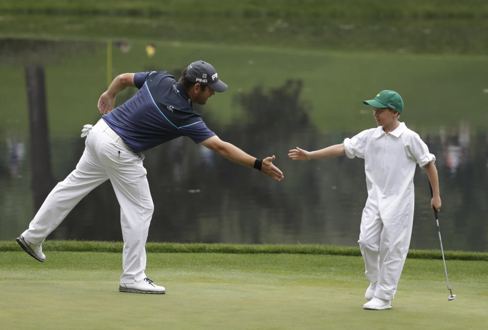 Louis Oosthuizen of South Africa, high fives Jacob Immelman on the ninth hole during the par three competition at the Masters golf tournament Wednesday, April 5, 2017, in Augusta, Ga. (AP Photo/David Goldman)