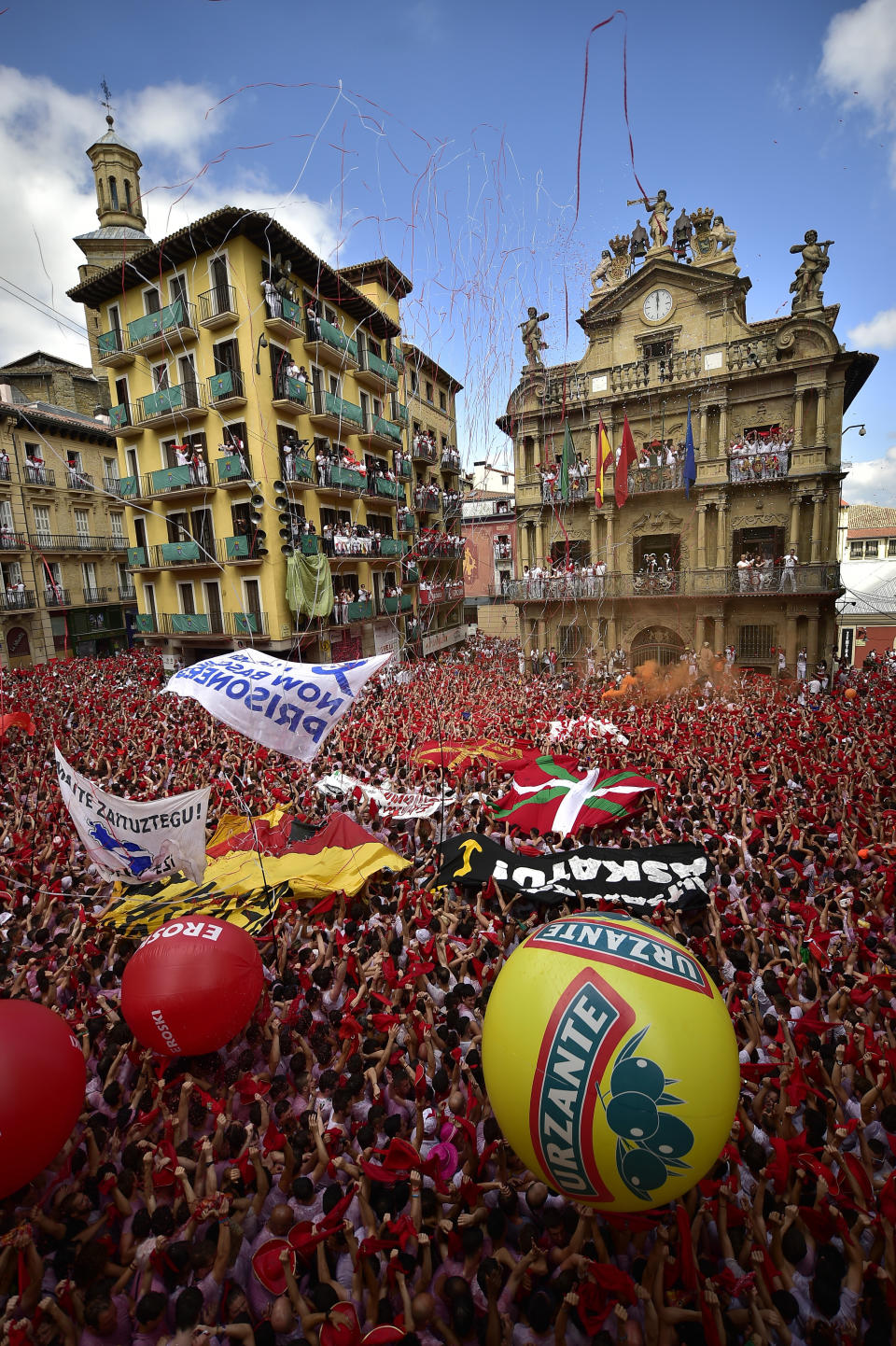 <p>Revellers hold up traditional red neckties during the launch of the ‘Chupinazo’ rocket, to celebrate the official opening of the 2018 San Fermin fiestas with daily bull runs, bullfights, music and dancing in Pamplona, Spain, Friday July 6, 2018. (Photo: Alvaro Barrientos/AP) </p>