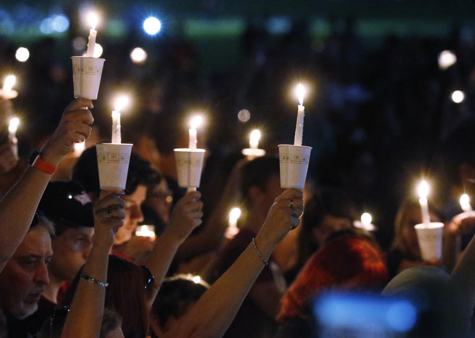 FILE - Attendees raise their candles at a candlelight vigil for the victims of the shooting at Marjory Stoneman Douglas High School, on Feb. 15, 2018, in Parkland, Fla. A jury on Thursday, Oct. 13, 2022, recommended a sentence of life without parole for Nikolas Cruz, attacker in the 2018 shooting massacre that left 17 people dead at the Florida high school. (AP Photo/Wilfredo Lee, File)