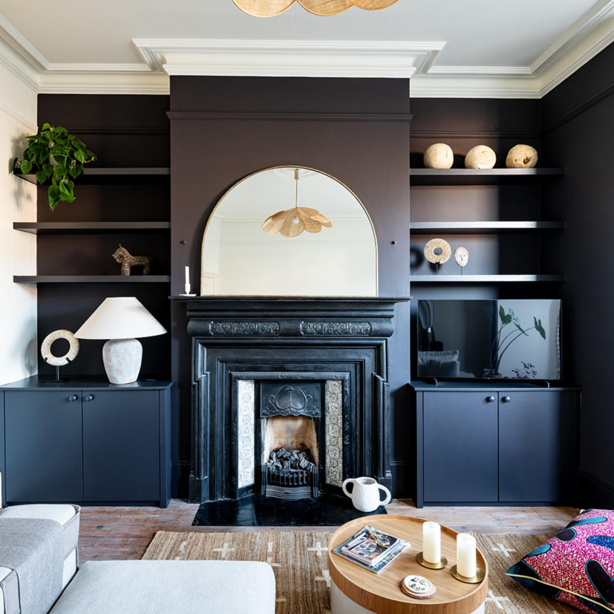  Living room with black painted cabinetry and fireplace. 