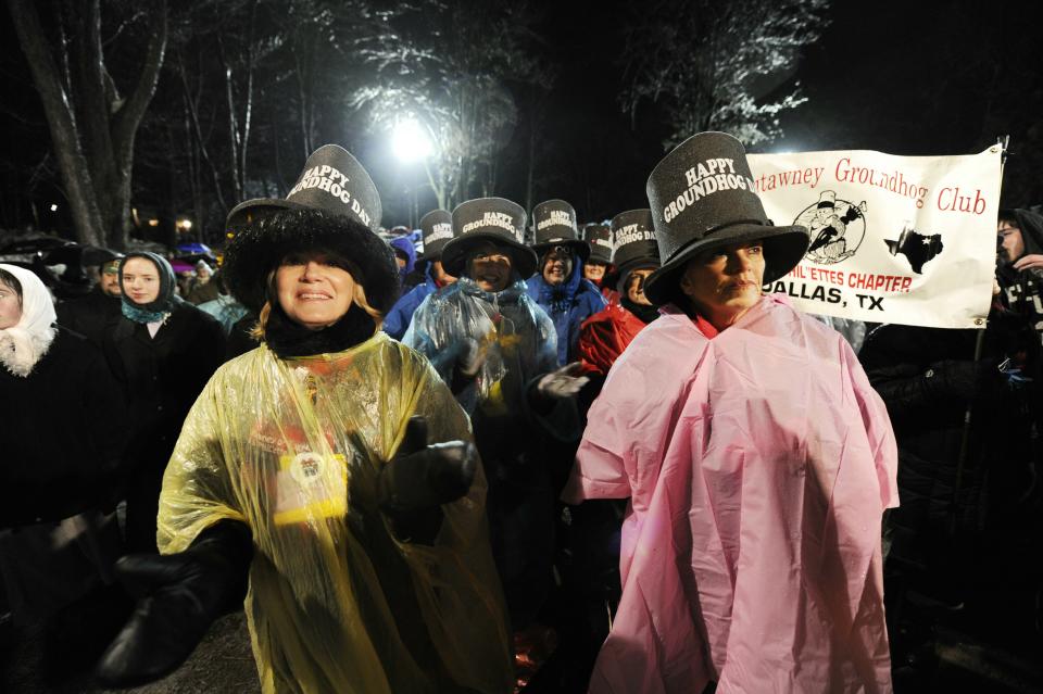 PUNXSUTAWNEY, PA - FEBRUARY 2: A crowd gathers to watch Punxsutawney Phil come out of his burrow during the 125th annual Groundhog Day festivities on February 2, 2011 in Punxsutawney, Pennsylvania. Phil came out and did not see his shadow predicting an early spring. Groundhog Day is a popular tradition in the United States and Canada. A smaller than usual crowd this year of less than 15,000 people spent a night of revelry awaiting the sunrise and the groundhog's exit from his winter den. If Punxsutawney Phil sees his shadow he regards it as an omen of six more weeks of bad weather and returns to his den. Early spring arrives if he does not see his shadow causing Phil to remain above ground. (Photo by Jeff Swensen/Getty Images)