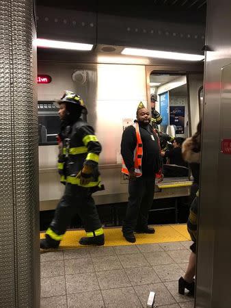 Emergency personnel gather inside the Atlantic Avenue Terminal after a commuter train derailed during the Wednesday morning commute, in New York, U.S., January 4, 2017. Steven Zundell/Handout via REUTERS