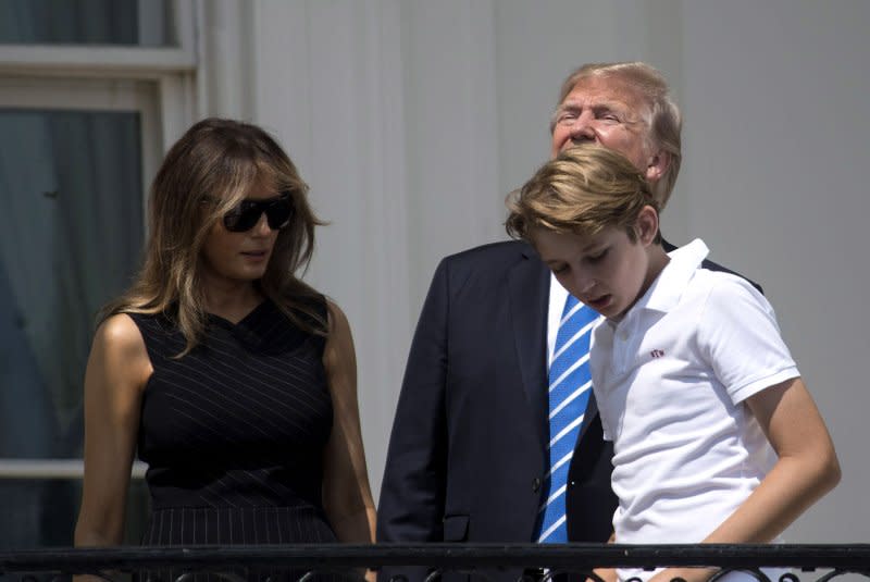 President Donald Trump looks at the solar eclipse without glasses -- which can cause eye damage --as he is joined by first lady Melania Trump and their son, Barron, at the White House on August 21, 2017. File Photo by Kevin Dietsch/UPI