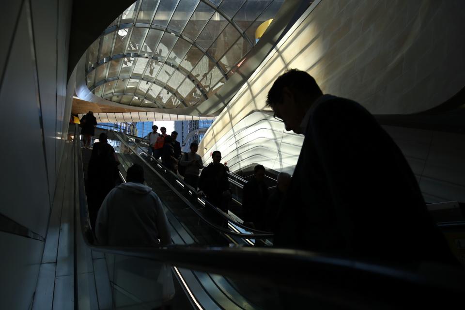 Commuters ride escalators as they go through the Wynyard Walk pedestrian tunnel at Wynyard railway station in Sydney, Australia, on Monday, July 30, 2018. 