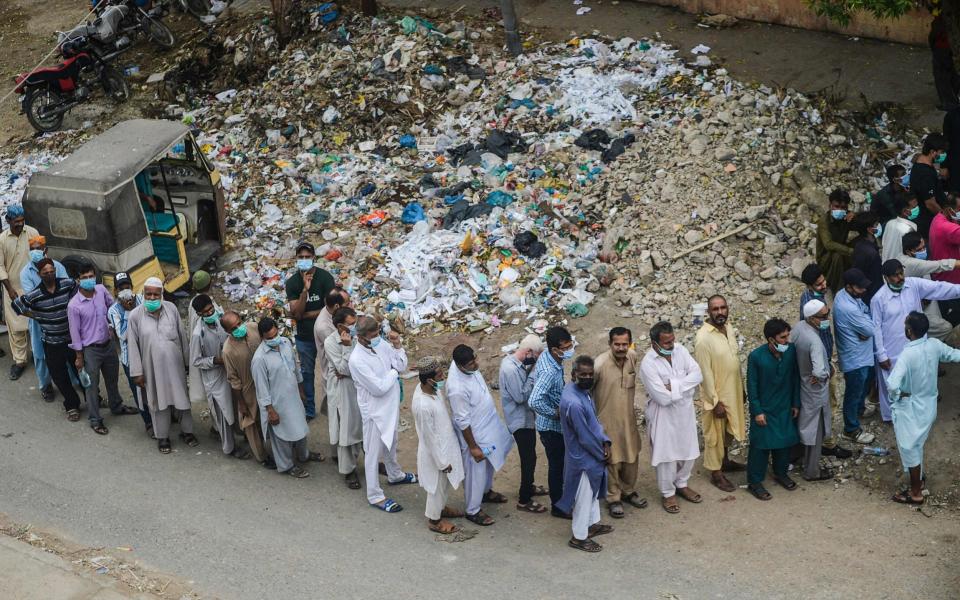 People queue to get vaccinated against Covid-19 in Karachi, Pakistan on 1 August 2021 - Rizwan Tabassum/AFP