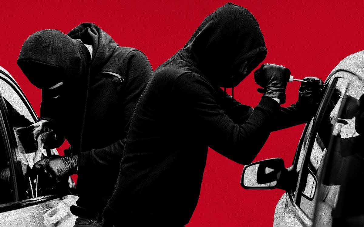 Two people breaking into a car against a red backdrop