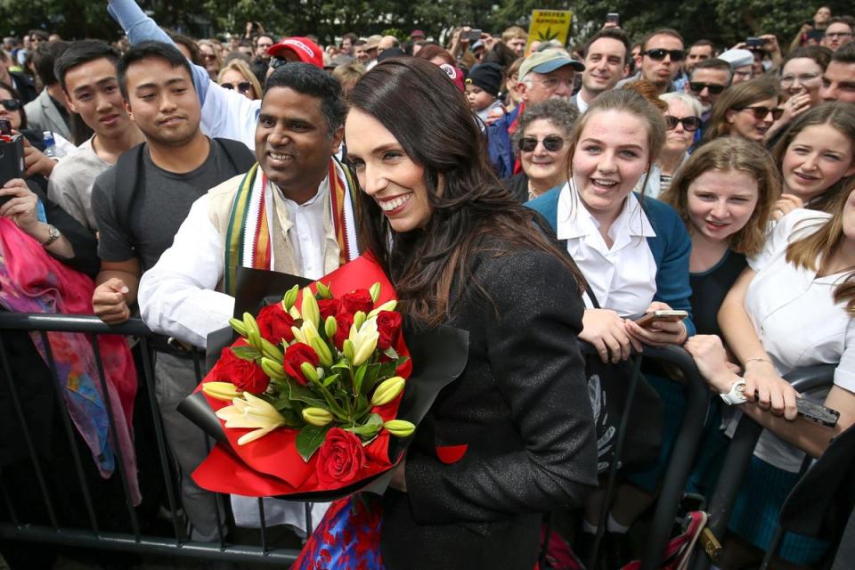 Prime Minister Jacinda Ardern is given a bunch of flowers while arriving at Parliament after a swearing-in ceremony at Government House on 26 October 2017 in Wellington, New Zealand (Getty Images)