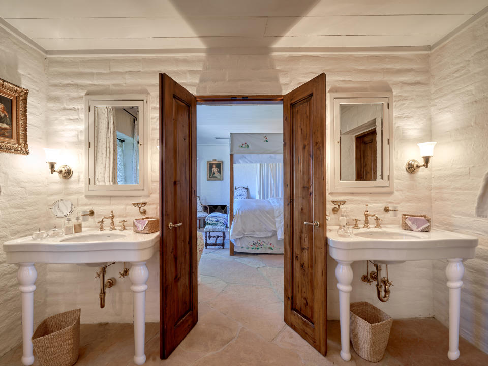 The master bedroom and master bath feature natural rock walls. (Credit: Douglas Elliman)