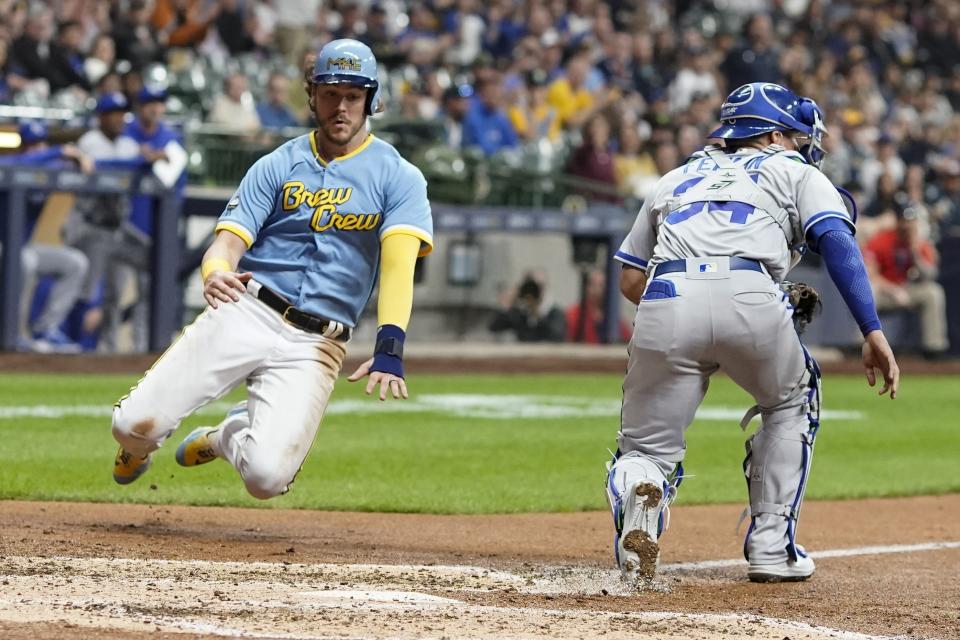 Milwaukee Brewers' Brian Anderson scores past Kansas City Royals catcher Freddy Fermin during the fourth inning of a baseball game Friday, May 12, 2023, in Milwaukee. Anderson scored on a hit by Tyrone Taylor. (AP Photo/Morry Gash)