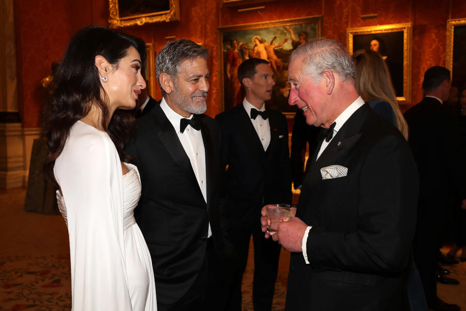 Amal and George Clooney speak to Prince Charles at a dinner in celebration of The Prince’s Trust [Photo: Getty]