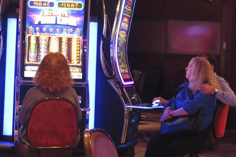Gamblers play slot machines at Harrah's casino in Atlantic City, N.J., on Sept. 29, 2023. On Nov. 21, 2023, New Jersey gambling regulators said Atlantic City's casinos and two internet-only entities earned $281.2 million in the third quarter of this year, a decline of 7.5% from the same period a year ago. (AP Photo/Wayne Parry)