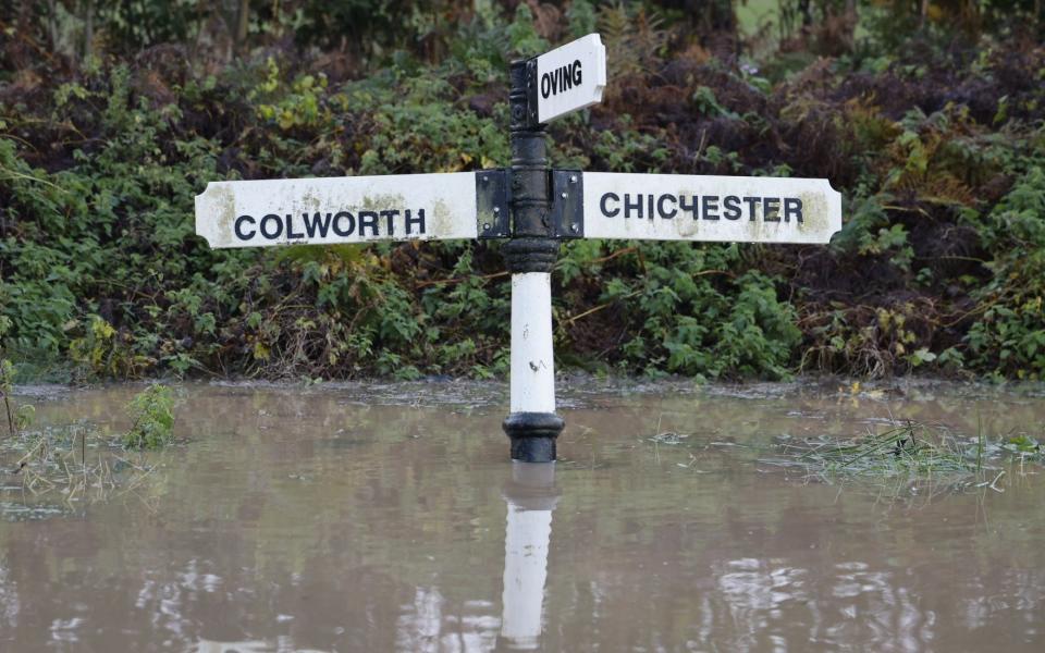 A road sign is submerged in floodwater near Bognor Regis