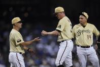 Arizona Diamondbacks manager Torey Lovullo, left, takes the ball from relief pitcher Joe Mantiply, middle, as third baseman Asdrubal Cabrera (14) waits during the eighth inning of the team's baseball game against the Los Angeles Dodgers on Friday, June 18, 2021, in Phoenix. The Dodgers won 3-0. (AP Photo/Ross D. Franklin)