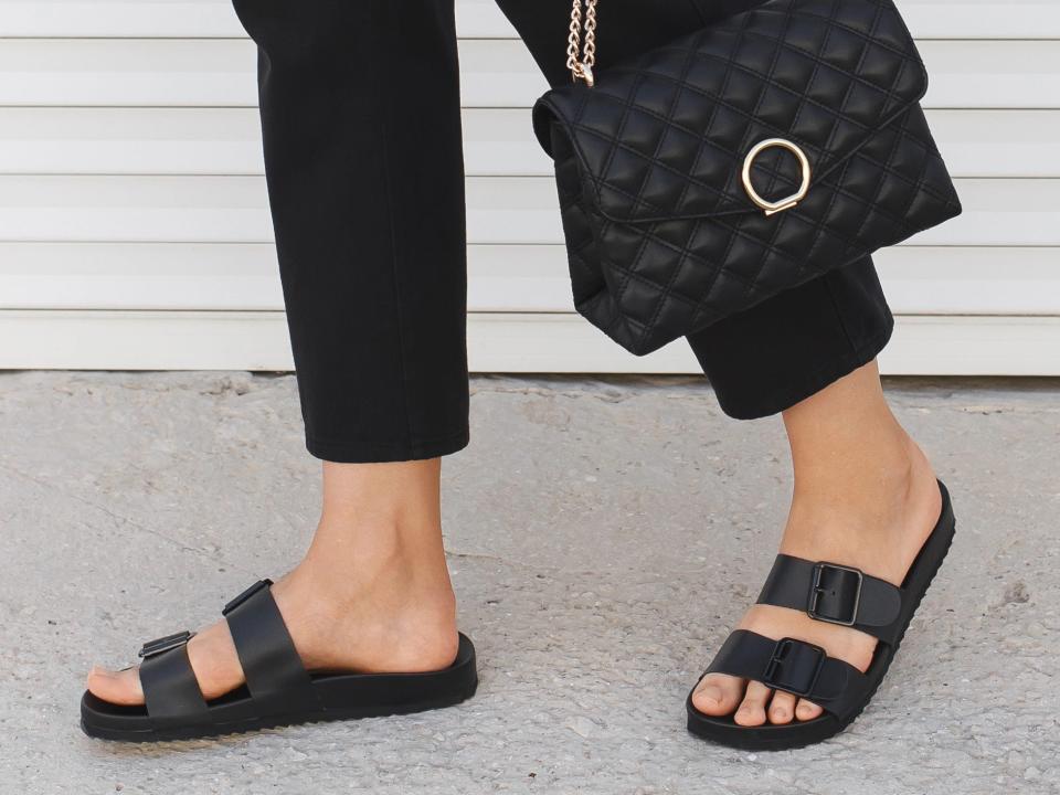 woman wearing simple black and white outfit with basic black sandals