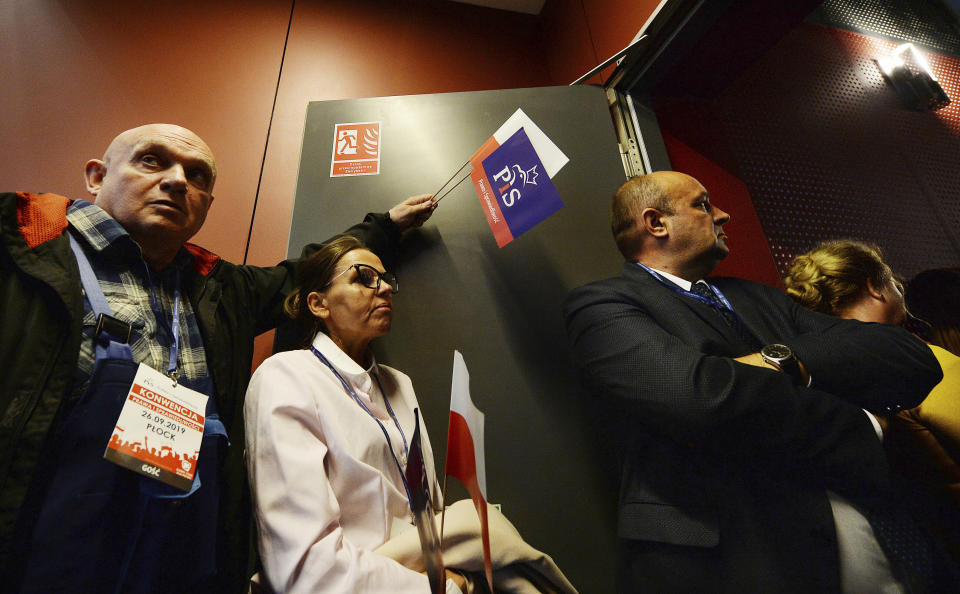 In this photo taken Thursday Sept. 26, 2019 supporters of Poland's ruling right-wing party attend a convention in Plock, Poland, ahead of Sunday parliamentary election in which his Law and Justice party is hoping to win a second term in power. (AP Photo/Czarek Sokolowski)