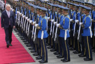 New Zealand's Prime Minister Christopher Luxon, left, reviews an honor guard during a welcome ceremony at the government house in Bangkok, Thailand, Wednesday, April 17, 2024. (AP Photo/Sakchai Lalit)