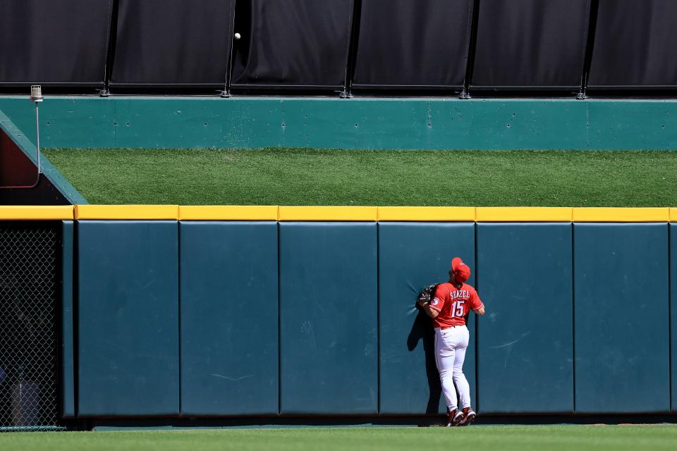 Cincinnati Reds center fielder Nick Senzel (15) chases a home run ball off the bat of Milwaukee Brewers shortstop Willy Adames (27) in the third inning of the MLB National League game between the Cincinnati Reds and the Milwaukee Brewers at Great American Ball Park in downtown Cincinnati on Saturday, June 18, 2022. The Brewers led 4-0 after four innings. 