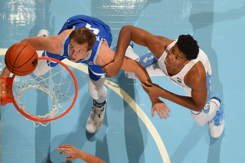 Mar 4, 2017; Chapel Hill, NC, USA; Duke Blue Devils guard Luke Kennard (5) and North Carolina Tar Heels forward Isaiah Hicks (4) under the basket. The Tar Heels defeated the Blue Devils 90-83 at Dean E. Smith Center. Mandatory Credit: Bob Donnan-USA TODAY Sports