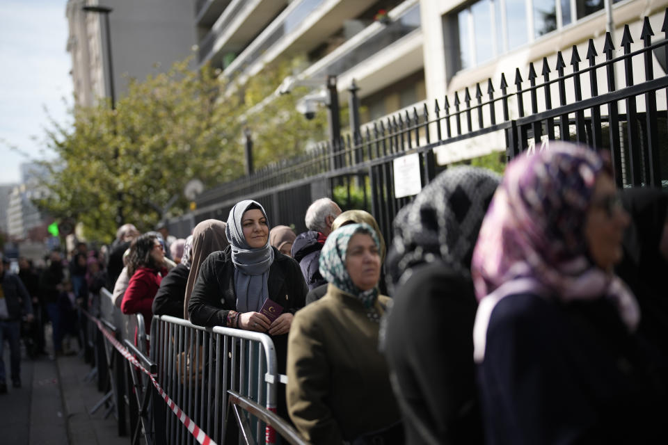 Turkish citizens queue to vote, outside the Turkish consulate, Thursday, April 27, 2023 Boulogne-Billancourt, outside Paris. The voting for the upcoming Turkish election begins on Thursday, with Turkish overseas citizens being the first ones allowed to cast their ballots at embassies and consulates. Turkey votes on Sunday in presidential and parliamentary elections that could extend the increasingly authoritarian President Recep Tayyip Erdogan's two-decades in power or tilt the country toward what his opponents promise to a more democratic one. (AP Photo/Christophe Ena)