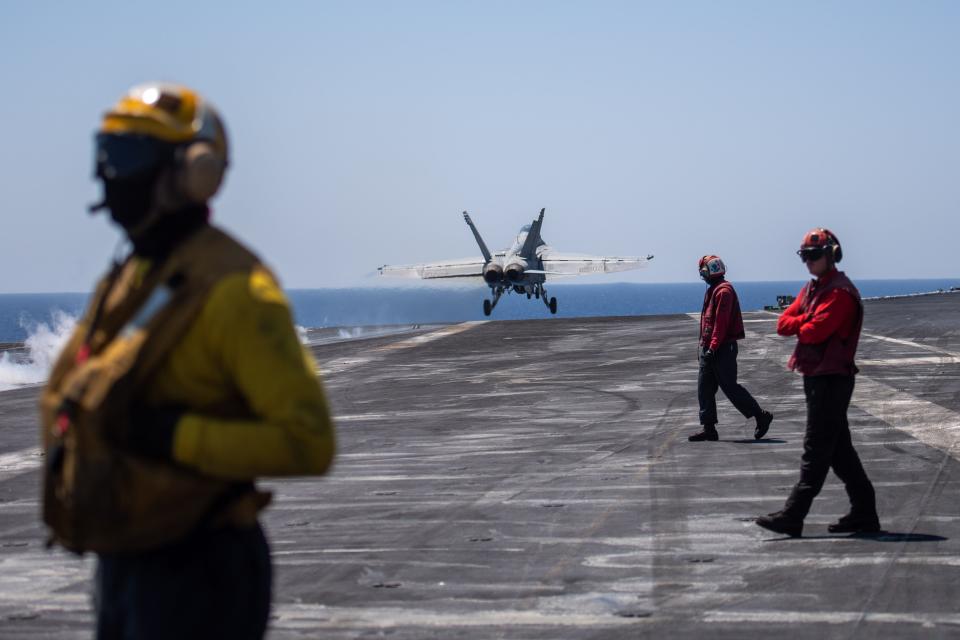 An F/A-18F Super Hornet, attached to the "Fighting Swordsmen" of Strike Fighter Squadron 32, aboard the Nimitz-class aircraft carrier USS Dwight D. Eisenhower launches from the flight deck during an airborne change of command ceremony in the Red Sea on April 16.