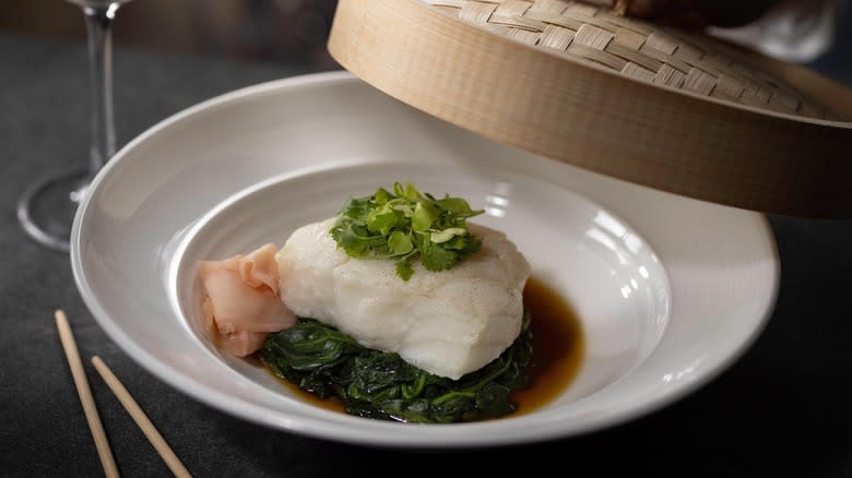 Plated sea bass on greens