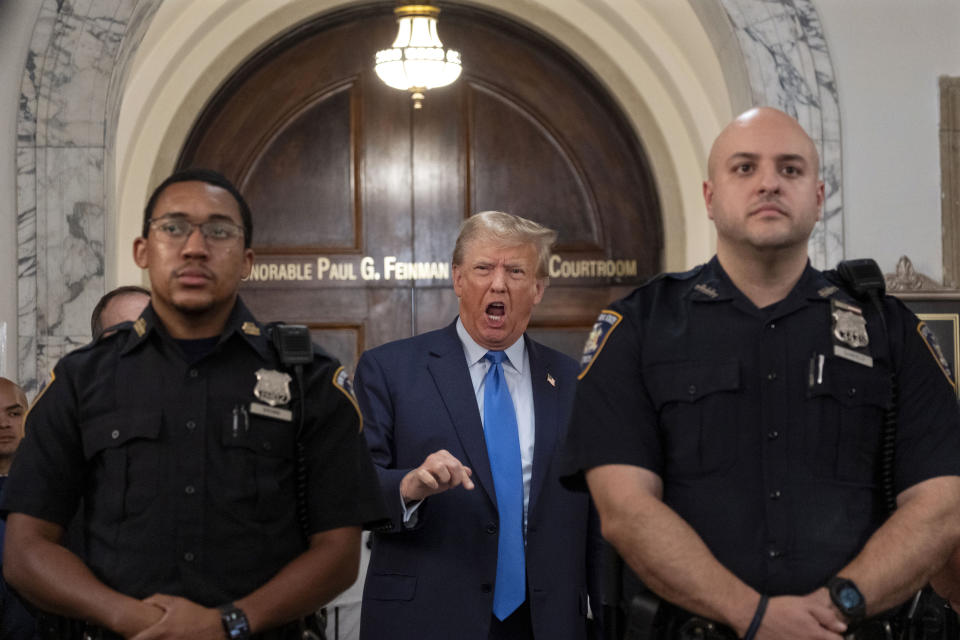 Former President Donald Trump speaks with journalists during a midday break from court proceedings in New York, Monday, Oct. 2, 2023, as he attends the start of a civil trial in a lawsuit that already has resulted in a judge ruling that he committed fraud in his business dealings. (AP Photo/Craig Ruttle)