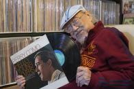 FILE - Ray Cordeiro, Hong Kong's oldest DJ displays records at his home in Hong Kong, Thursday, May 27, 2021. Cordeiro considers himself the luckiest radio DJ in the world. Cordeiro, who interviewed music acts including the Beatles during a six-decade career on Hong Kong radio that earned him the title of the world's longest-working disc jockey, died Friday, Jan. 13, 2023, his former employer announced. He was 98. (AP Photo/Kin Cheung, File)