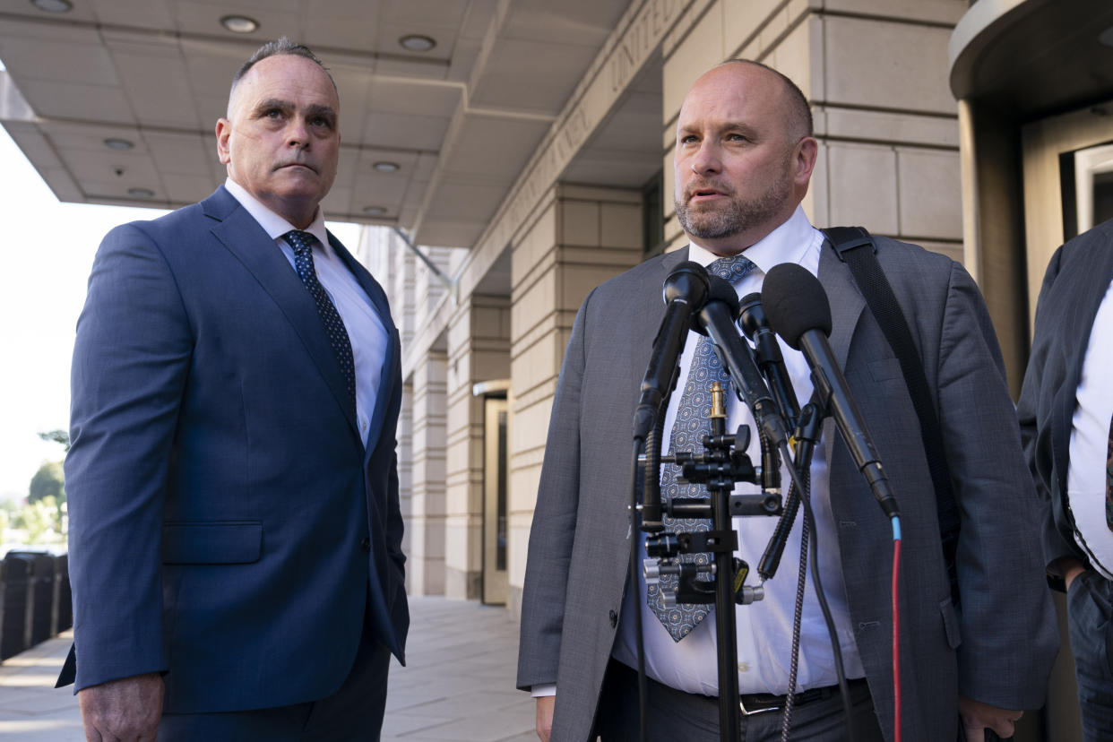 Retired New York Police Department officer Thomas Webster, left, listens as his attorney James Monroe speaks to members of the media outside the federal courthouse in Washington, Thursday, Sept. 1, 2022. Webster was sentenced on Thursday to 10 years in prison for attacking the U.S. Capitol and using a metal flagpole to assault one of the police officers trying to hold off a mob of Donald Trump supporters. (AP Photo/Jose Luis Magana)