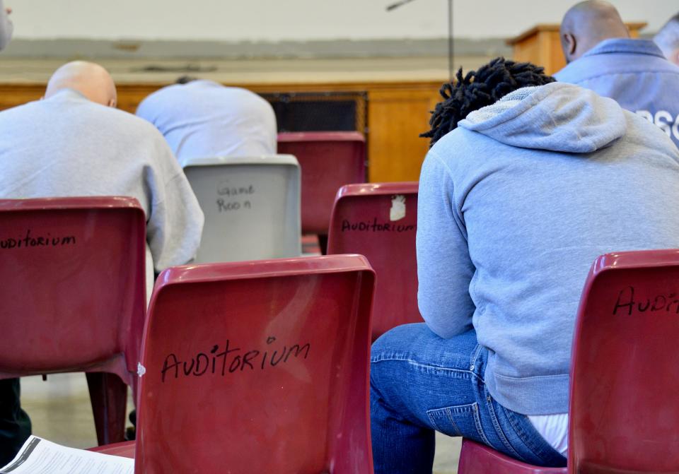 Maryland Correctional Institution-Hagerstown inmates praying Wednesday morning as they listen to former baseball star Darryl Strawberry, now an ordained minister.