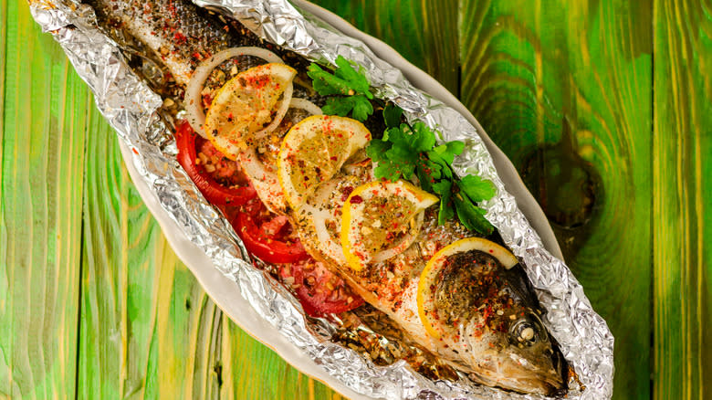 grilled fish and vegetables in aluminum foil