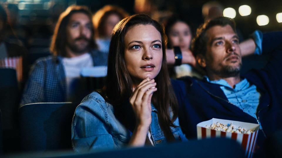 Close up of a couple enjoying a movie in the cinema.