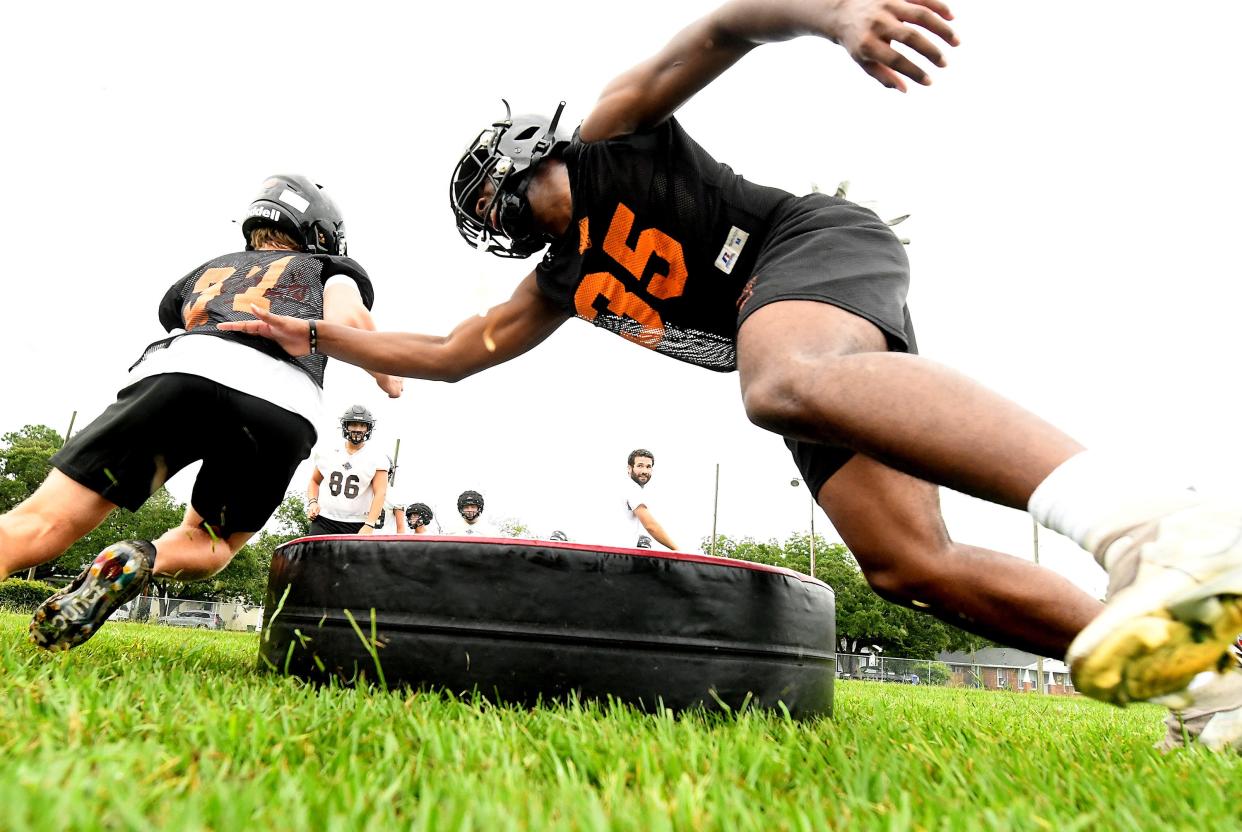 New Hanover goes through football practice drills early Monday morning July 31, 2023 in Wilmington, N.C. High School football started Monday with coaches and players hitting the practice fields across the area. KEN BLEVINS/STARNEWS