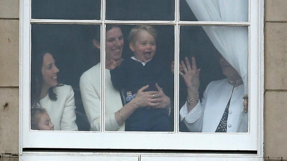 Prince George seen through the windows of Buckingham Palace