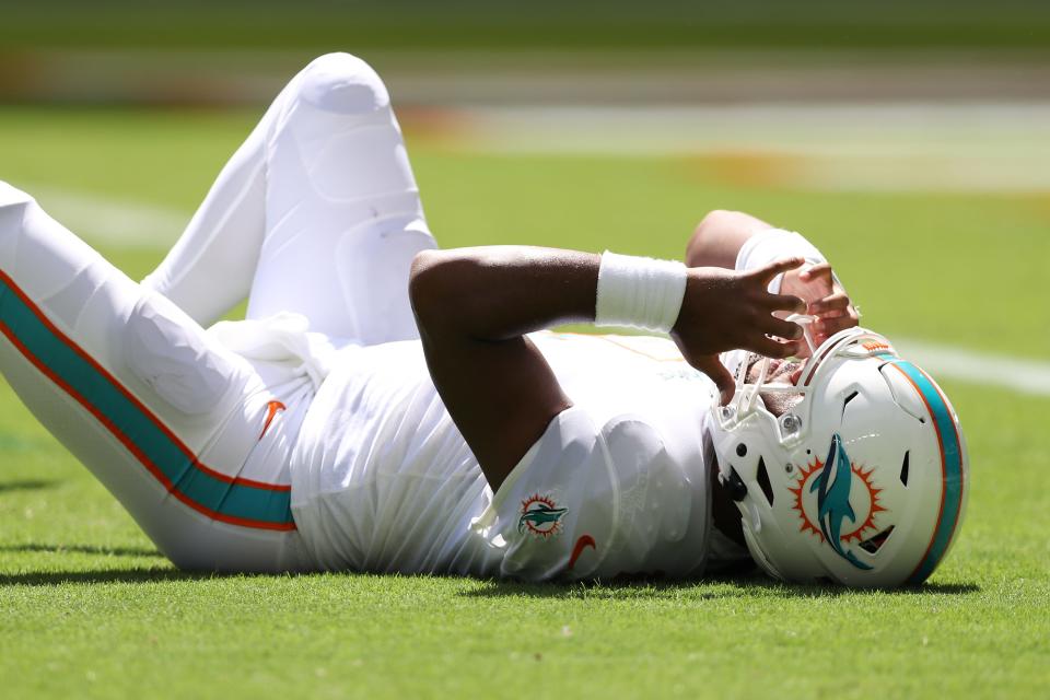 Dolphins QB Tua Tagovailoa lays on the turf during the second quarter against the Buffalo Bills at Hard Rock Stadium on Sept. 25, 2022.