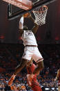 Illinois' Kofi Cockburn dunks during the first half of the team's NCAA college basketball game against Rutgers on Friday, Dec. 3, 2021, in Champaign, Ill. (AP Photo/Michael Allio)