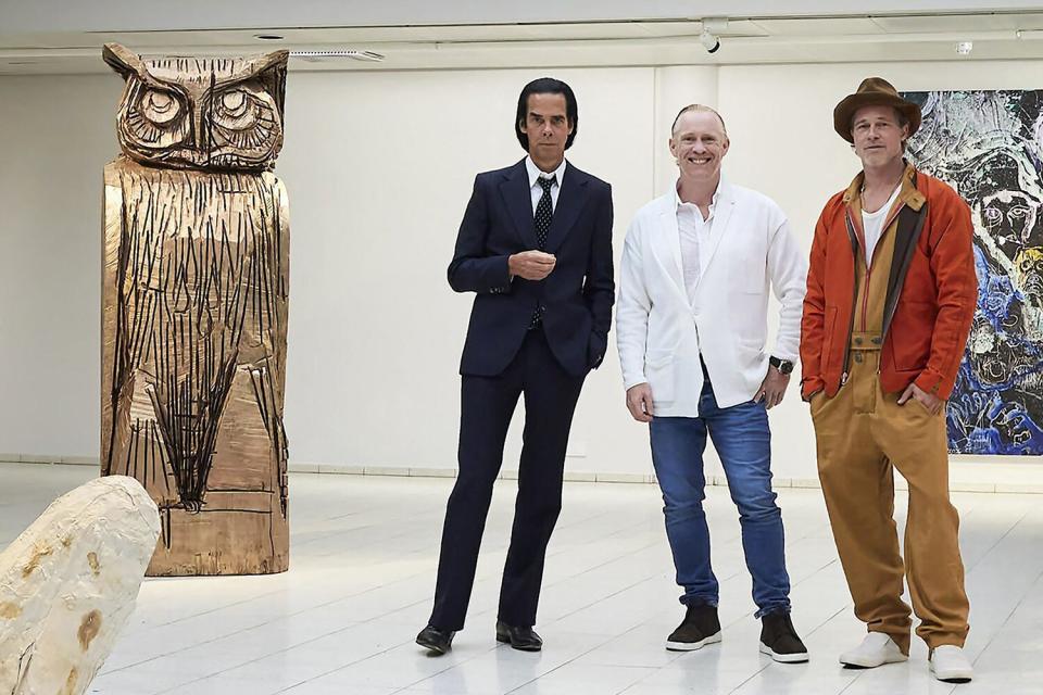 This handout photo taken on September 17, 2022 and received on September 19, 2022 shows British artist Thomas Houseago (C) posing with US actor Brad Pitt (R) and Australian musician Nick Cave prior to the opening of the exhibition 'Thomas Houseago - WE with Nick Cave and Brad Bitt' at The Sara Hilden Art Museum in Tampere, Finland.