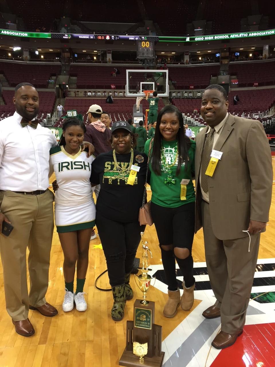 Willie McGee, left, smiles with niece, Amya McGee, sister-in-law, Vikkie McGee, niece, Aliya McGee, and brother, Illya McGee in 2017 after the St. Vincent-St. Mary boys basketball team won the Division II state championship at Ohio State University in Columbus.