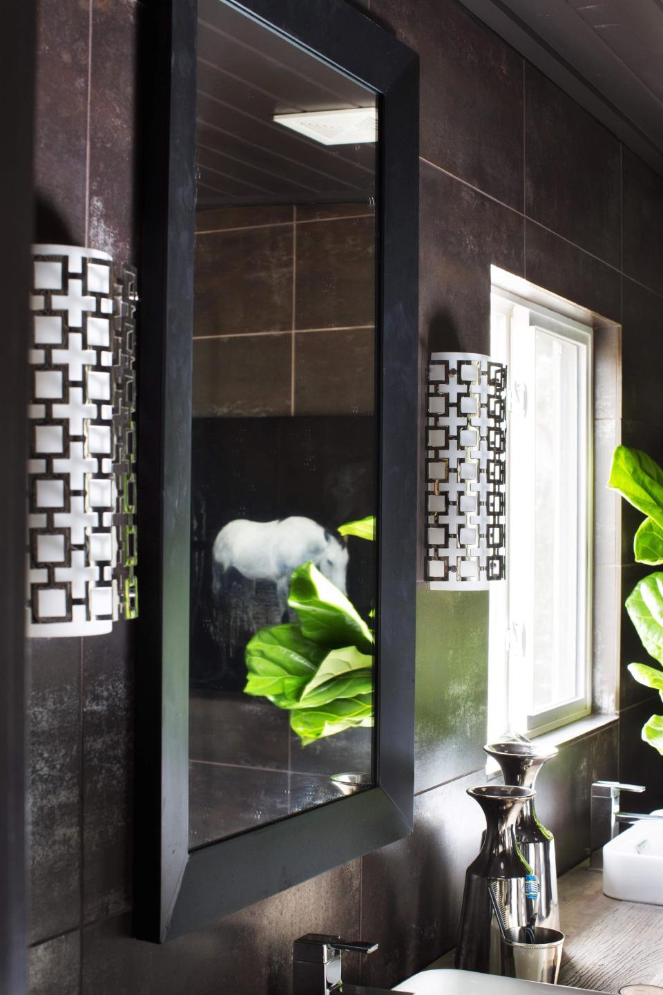 This undated publicity photo provided by Brian Patrick Flynn shows a pair of wall sconces used by Designer Brian Patrick Flynn to flank this bathroom vanity. The sconces add ample light, while also functioning as pieces of decorative art. (AP Photo/Brian Patrick Flynn, Sarah Dorio/Scripps Networks Interactive)