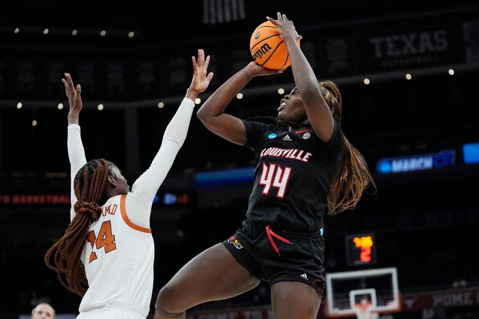 Louisville forward Olivia Cochran (44) shoots over Texas forward Amina Muhammad (14) during the first half of a second-round college basketball game in the NCAA Tournament in Austin, Texas, Monday, March 20, 2023. (AP Photo/Eric Gay)