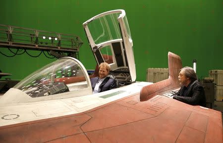 Britain's Prince Harry sits in an A-wing fighter as he talks with US actor Mark Hamill during a tour of the Star Wars sets at Pinewood studios in Iver Heath, west of London, Britain on April 19, 2016. REUTERS/Adrian Dennis/Pool