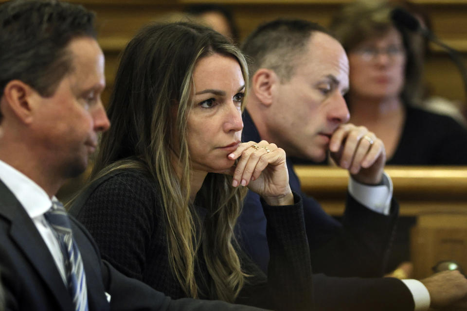 Defendant Karen Read sits with her defense team during her murder trial, Tuesday, April 30, 2024, in Dedham, Mass. Read, 44, of Mansfield, faces several charges including second degree murder in the death of her Boston Police officer boyfriend John O’Keefe, 46, in 2022. (Nancy Lane/The Boston Herald via AP, Pool)