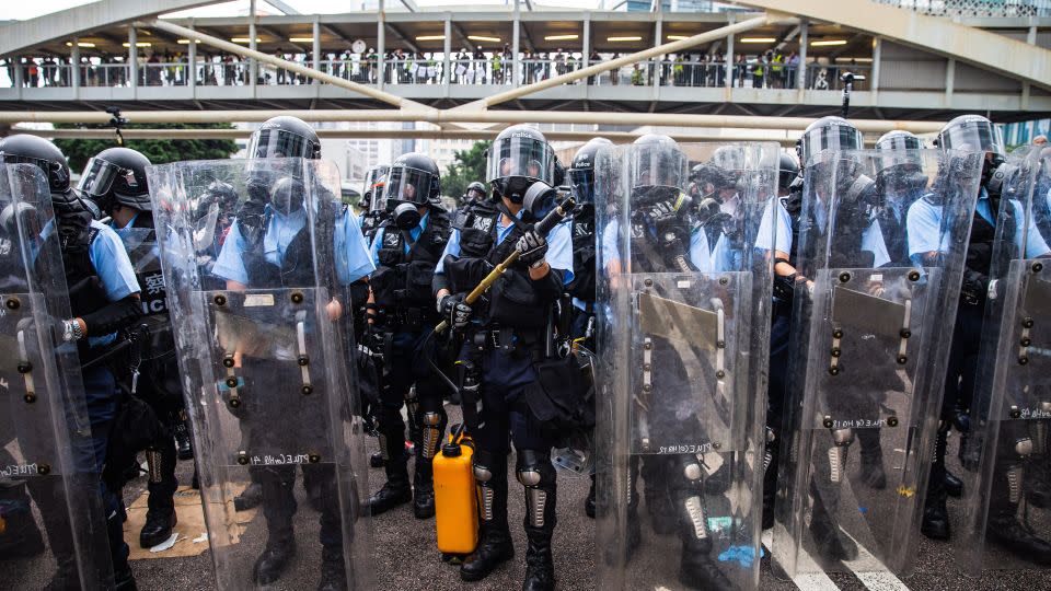 Riot police stand guard during a June 2019 protest in Hong Kong against a proposed extradition law that would have allowed extradition of fugitives to mainland China. - Sanjit Das/Bloomberg/Getty Images