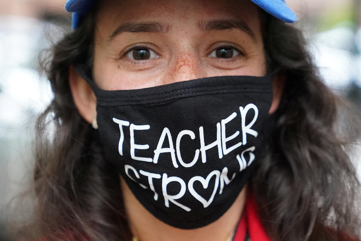 A woman wears a "Teacher Strong" face mask as she attends a rally to protest the opening of schools following the outbreak of the coronavirus disease (COVID-19) in the Brooklyn borough of New York City, New York, U.S., September 1, 2020.  REUTERS/Carlo Allegri