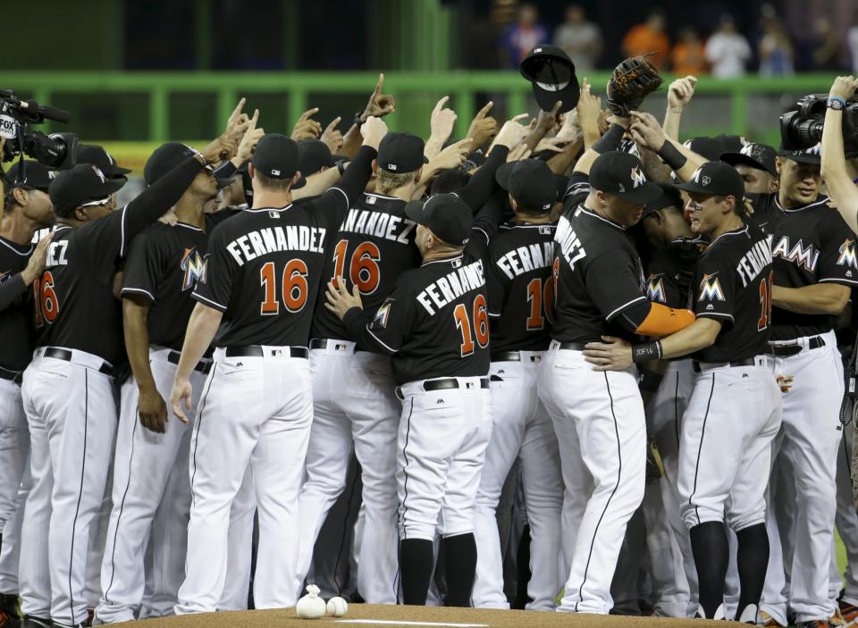 <p>Miami Marlins players wearing a jersey in honor of pitcher Jose Fernandez (16) gather around the pitching mound before a baseball game against the New York Mets, Monday, Sept. 26, 2016, in Miami. Fernandez died in a boating accident Sunday. (AP Photo/Lynne Sladky) </p>