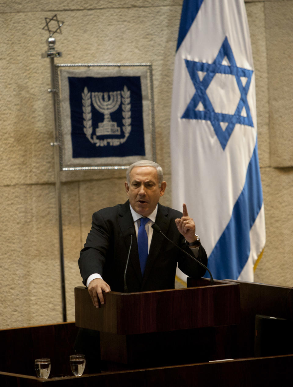 Israeli Prime Minister Benjamin Netanyahu gestures as he delivers a speech at the Knesset, Israel's parliament in Jerusalem, Monday, Oct. 15, 2012. Israel's parliament has gathered for a vote to dissolve itself and hold early parliamentary elections. (AP Photo/Sebastian Scheiner)